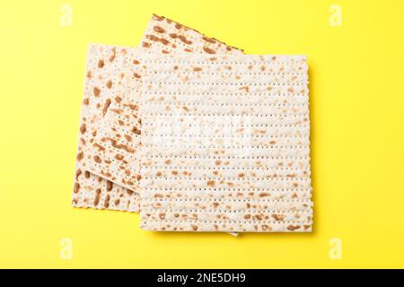 Traditional matzos on yellow background, flat lay Stock Photo