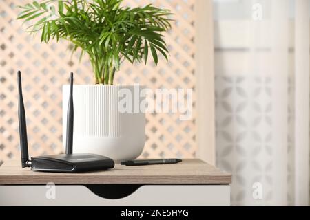 Modern Wi-Fi router indoors. Space for text Stock Photo
