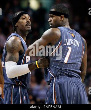 Charlotte Bobcats forward Gerald Wallace, left, grabs the jersey of  teammate Stephen Jackson (1), looking to calm him down during the second  half of an NBA basketball game against the Boston Celtics