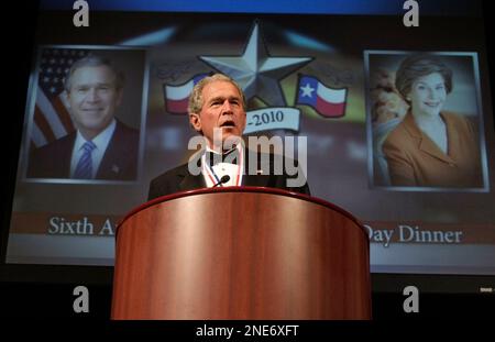 President George W. Bush (C) accepts a football jersey denoting