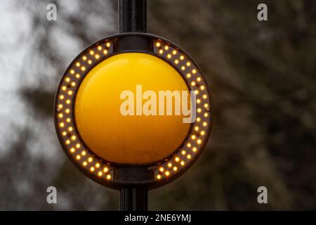 A modern Zebrite Belisha beacon with LED orange flashing lights surounding it and used at pedestrian crossings in West Yorkshire in the UK Stock Photo