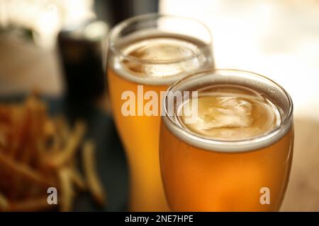 Glasses of fresh cool beer in cafe, closeup Stock Photo