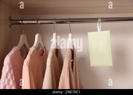 Scented sachet with flowers and stylish clothes on hanger Stock Photo -  Alamy