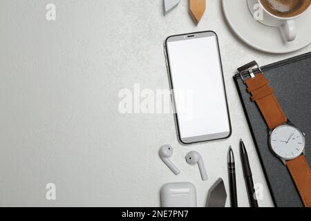 Flat lay composition with smartphone, cup of coffee and stationery on grey table, space for text Stock Photo