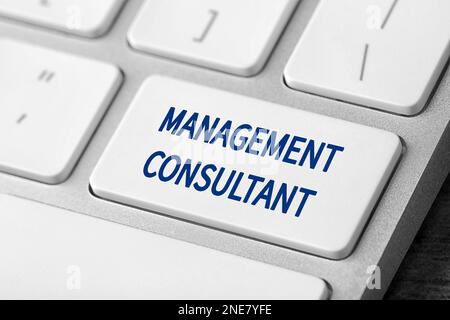 Button with text MANAGEMENT CONSULTANT on keyboard, closeup Stock Photo