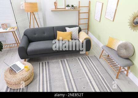 Stylish living room interior with comfortable sofa and lamp Stock Photo