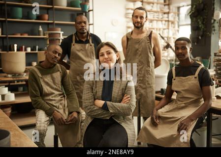 Smiling manager and her diverse team working in a ceramics studio Stock Photo