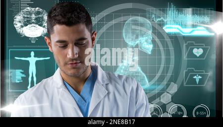Composition of male doctor over screen with medical data processing Stock Photo