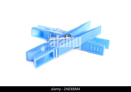 Light blue plastic clothespins on white background Stock Photo