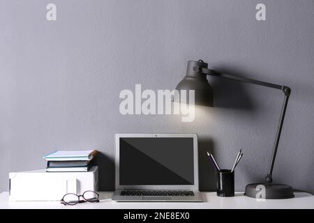Modern laptop on white table. Comfortable workplace Stock Photo