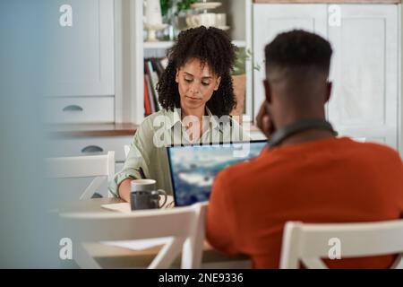 Multiracial couple working remotely from home on laptops Stock Photo
