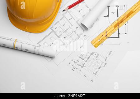 Flat lay composition with blueprints and hardhat on white background ...