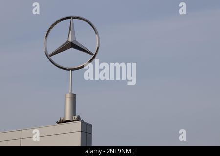 Poznan, Poland - February 16, 2023. Mercedes-Benz logo with a blue sky background. Stock Photo