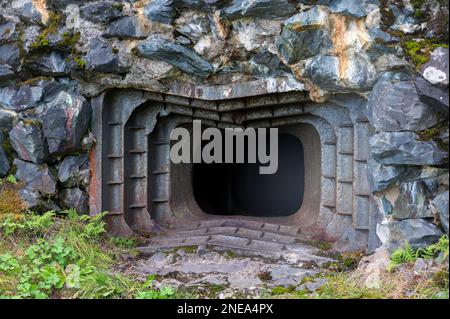 View of an abandoned bunker, an old military pillbox. Old millitary building carved into the rock. Military pillbox in Russia, Medvezhyegorsk. Stock Photo