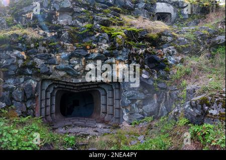 View of an abandoned bunker, an old military pillbox. Old millitary building carved into the rock. Military pillbox in Russia, Medvezhyegorsk. Stock Photo