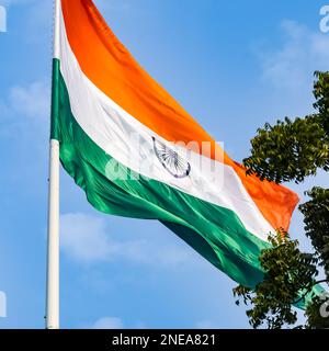 India flag flying high at Connaught Place with pride in blue sky, India flag fluttering, Indian Flag on Independence Day and Republic Day of India, ti Stock Photo