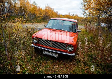 CAUCASUS, RUSSIAN - NOVEBMBER, 07, 2021:1970-car Jiguli Vaz-2101. Orange car surrounded by autumn trees and bushes, close-up photo. Stock Photo