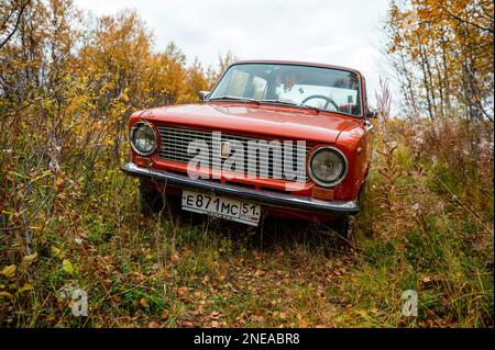CAUCASUS, RUSSIAN - NOVEBMBER, 07, 2021:1970-car Jiguli Vaz-2101. Orange car surrounded by autumn trees and bushes, close-up photo. Stock Photo