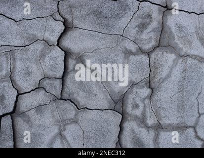 Old cracked painted plaster wall, cracked rough abstract banner surface. Stock Photo