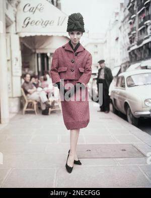 Potomac is a tailor made suit of burnt brown woolen tweed, worn with a blouse of bronze coloured jersey stuff. Hat is to match, in bronze coloured wool, August 18, 1960. (AP Photo/Godot)