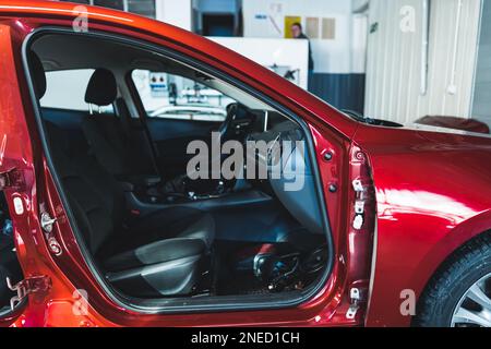 Medium shot of red car without doors. Repair shop concept. High quality photo Stock Photo