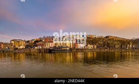 Panoramic view of the Grain Barge moored on the river Avon with rows of colourful houses behind, seen from Bristol marina looking North at sunrise. Stock Photo