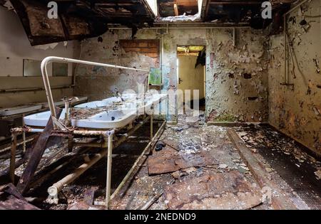 Dilapidated washroom many washbasins Stock Photo