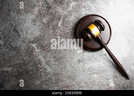 directly above view of judges gavel on marble stone table background Stock Photo