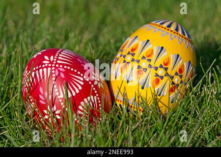 Two traditionally hand-painted Easter eggs lie in the grass Stock Photo
