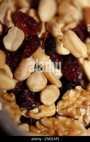 Mix of dried cranberries fruits almonds and nuts in a bowl close up modern background high quality big size stock photos print Stock Photo