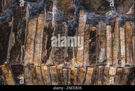 Facing material for finishing the facades of buildings. Facade cladding made of sandstone, slate Stock Photo