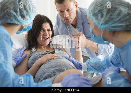 Woman giving child birth in maternity hospital Stock Photo - Alamy