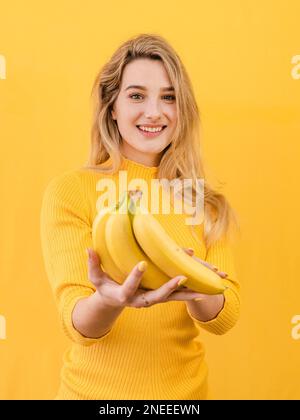 front view woman holding bananas Stock Photo