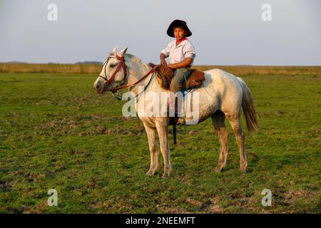 Young Gaucho on his horse at Puesto Mingo, Esteros del Ibera, near Concepcion del Yaguarete Cora, Corrientes Province, Argentina Stock Photo