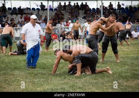 Oil wrestling. Wrestle. Men doing classic Turkish sports. Athletes greeting the audience. September 2022 Turkey. Stock Photo
