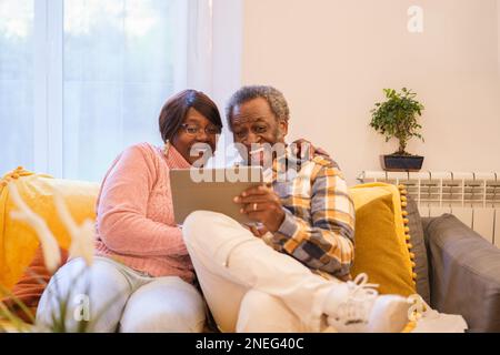 Senior couple using new technologies and testing innovations with the tablet. Concept: Technology, retirees, full life Stock Photo