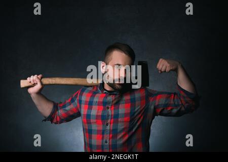 Strong woodsman with axe. Male strength Stock Photo