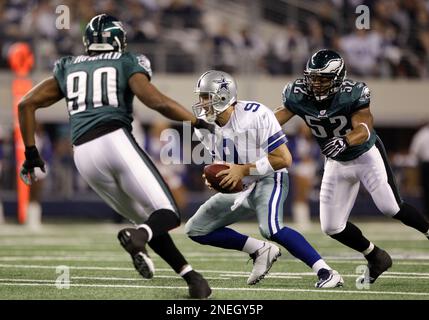 Philadelphia Eagles defensive end Darren Howard (90) hits Dallas Cowboys  quarterback Tony Romo (9) as throws the ball in first half action in the NFL  - NFC Playoffs football game between the