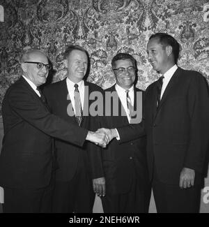 George Halas, owner-president of the Chicago Bears, seems to have some  interested listeners in Jack Jennings, center, of the Chicago Cardinals,  and Chuck Bednarik, right, of the Philadelphia Eagles, as they wait