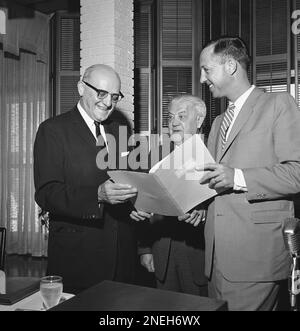 George Halas, owner-president of the Chicago Bears, seems to have some  interested listeners in Jack Jennings, center, of the Chicago Cardinals,  and Chuck Bednarik, right, of the Philadelphia Eagles, as they wait