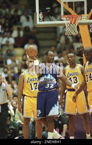 Utah Jazz? Karl Malone (32) holds up the ball as he walks up to