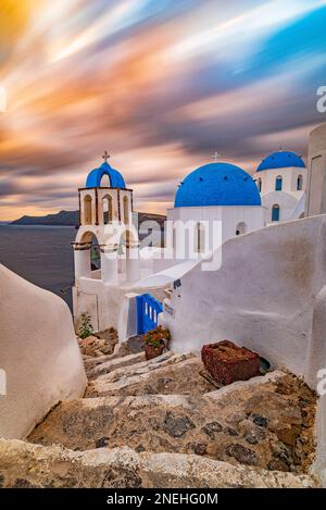 View on the picturesque church with the three blue domes at dusk, Santorini Stock Photo