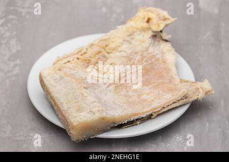 salted cod fish on white small dish on ceramic Stock Photo