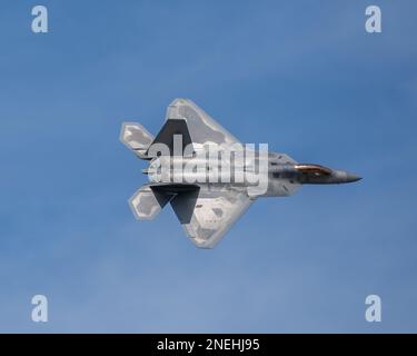 A F-22 Raptor shows off its skills in an aerial acrobatic demonstration ...