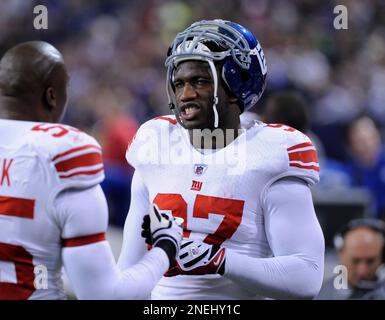 Jacksonville Jaguars running back Rashad Jennings (23) wards off New York  Giants linebacker Clint Sintim (52) on a long run into the red zone during  first half week 12 NFL action between