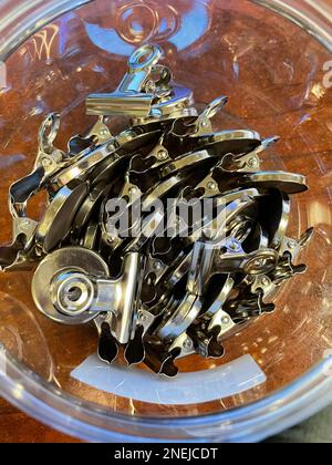 Plastic container of Magnetic Bulldog Clips for the office . High quality photo Stock Photo