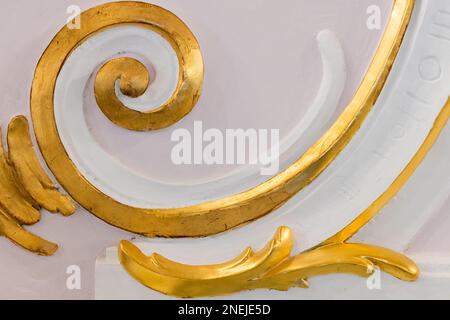 White gypsum bas-relief with gold colored details, wall design, rococo style, classic architecture abstract template Stock Photo