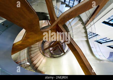 Spiral staircase seen from above and with artificial lighting. Fibonacci spiral. Golden ratio. Stock Photo