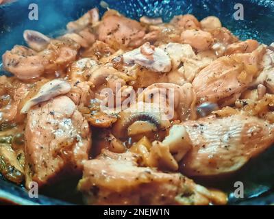 Healthy home made delicious chicken meat cooked with fresh mushrooms, onion and herbs, keto food Stock Photo