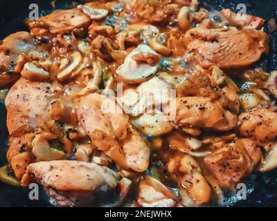 Healthy home made delicious chicken meat cooked with fresh mushrooms, onion and herbs, keto food Stock Photo